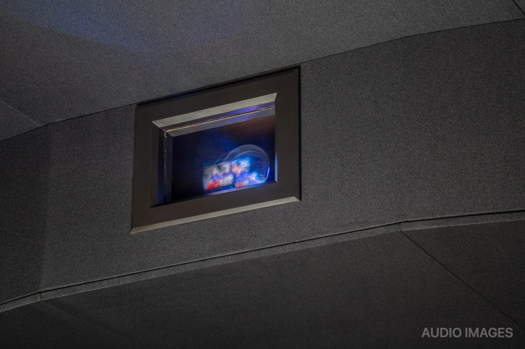 Eagle’s Nest — recessed projector lens set flush into the theater's rear wall.