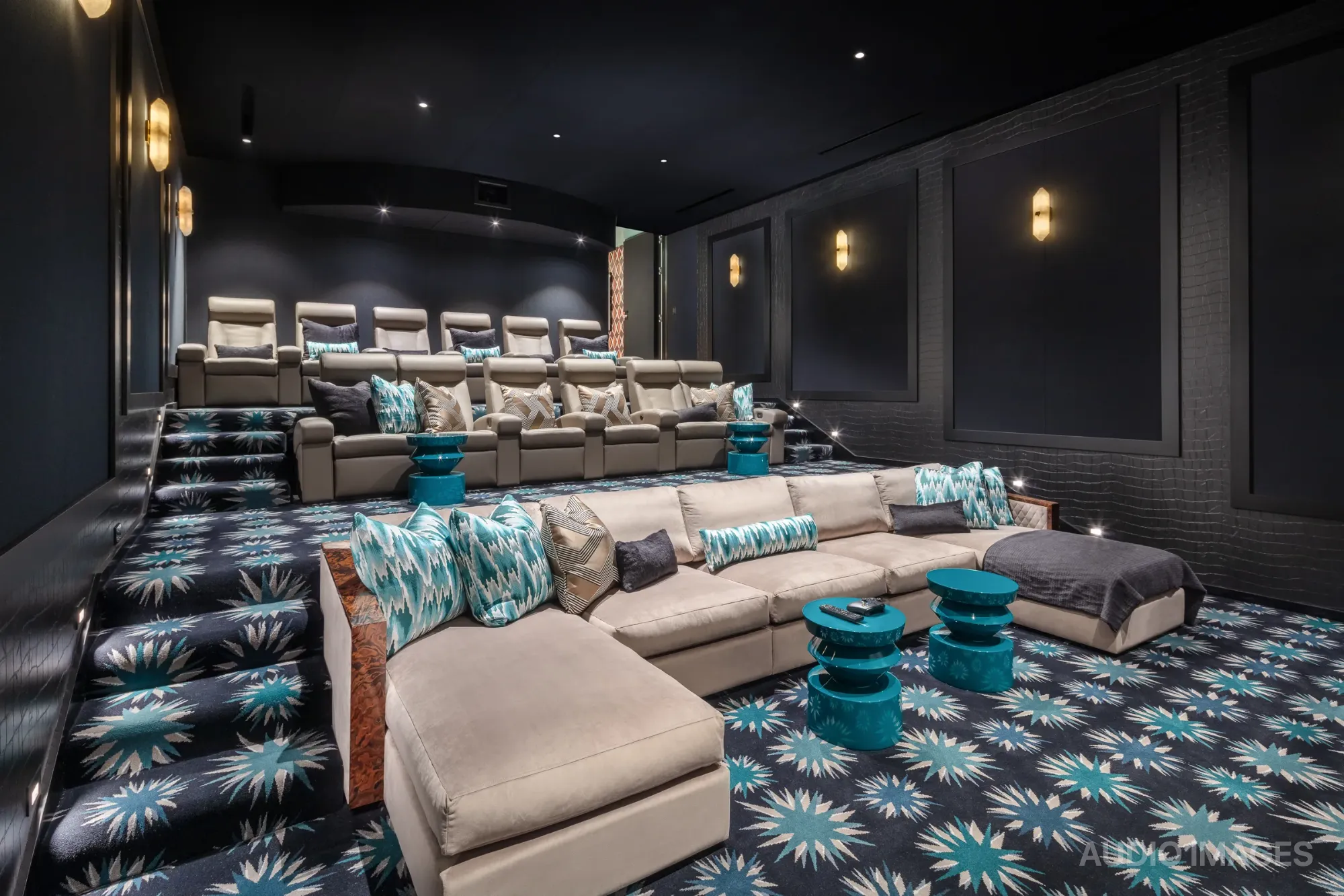 Eagle’s Nest — tiered rows of custom leather seating facing the 210-inch screen.