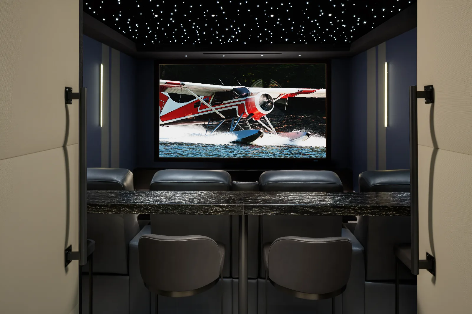 View into a luxurious home theater from open doors, featuring a starry ceiling, large screen showing a seaplane, and bar seating.