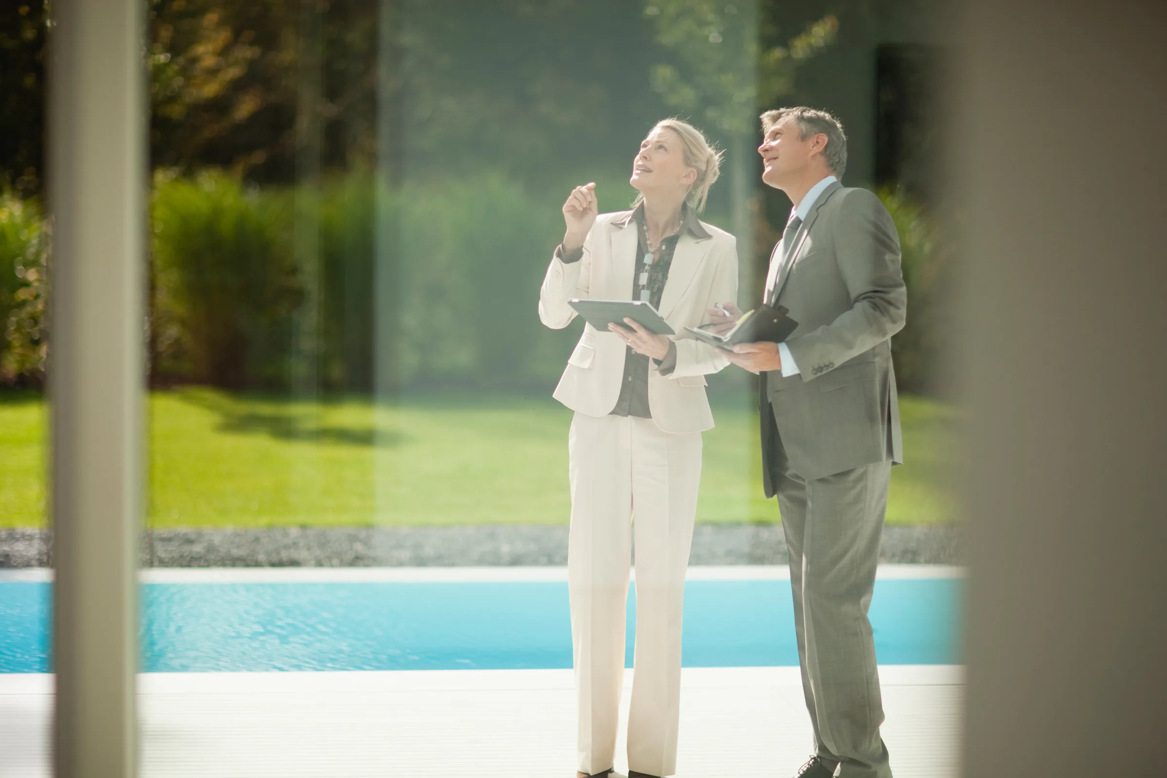 Real estate agents reviewing a luxury property with integrated technology